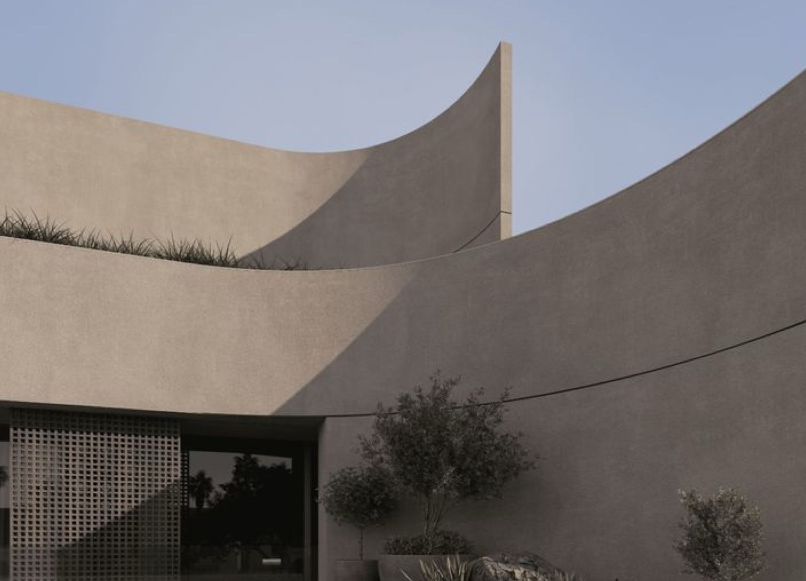 Curved concrete facade against a desert sky